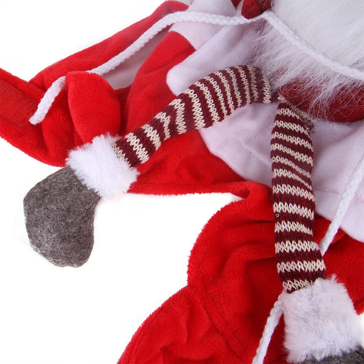 Close-up of a red and white plush toy with striped legs on a white background