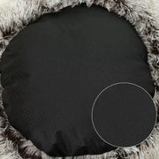 Black circular object on a textured brown surface