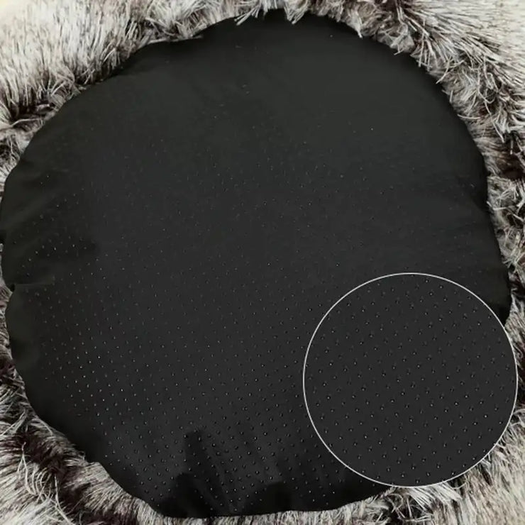 Black circular object on a textured brown surface