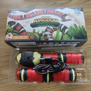 Toy snake with USB cable in clear packaging, on a wooden surface with 'Animal Kingdom' box in the background.