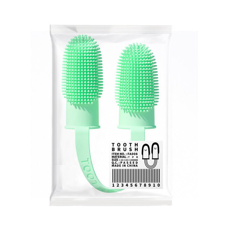 Two green silicone toothbrushes in packaging with a white background