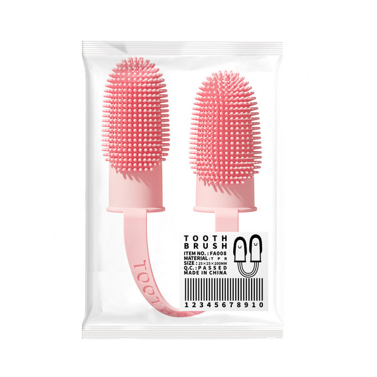 Pink silicone toothbrushes in packaging on a white background